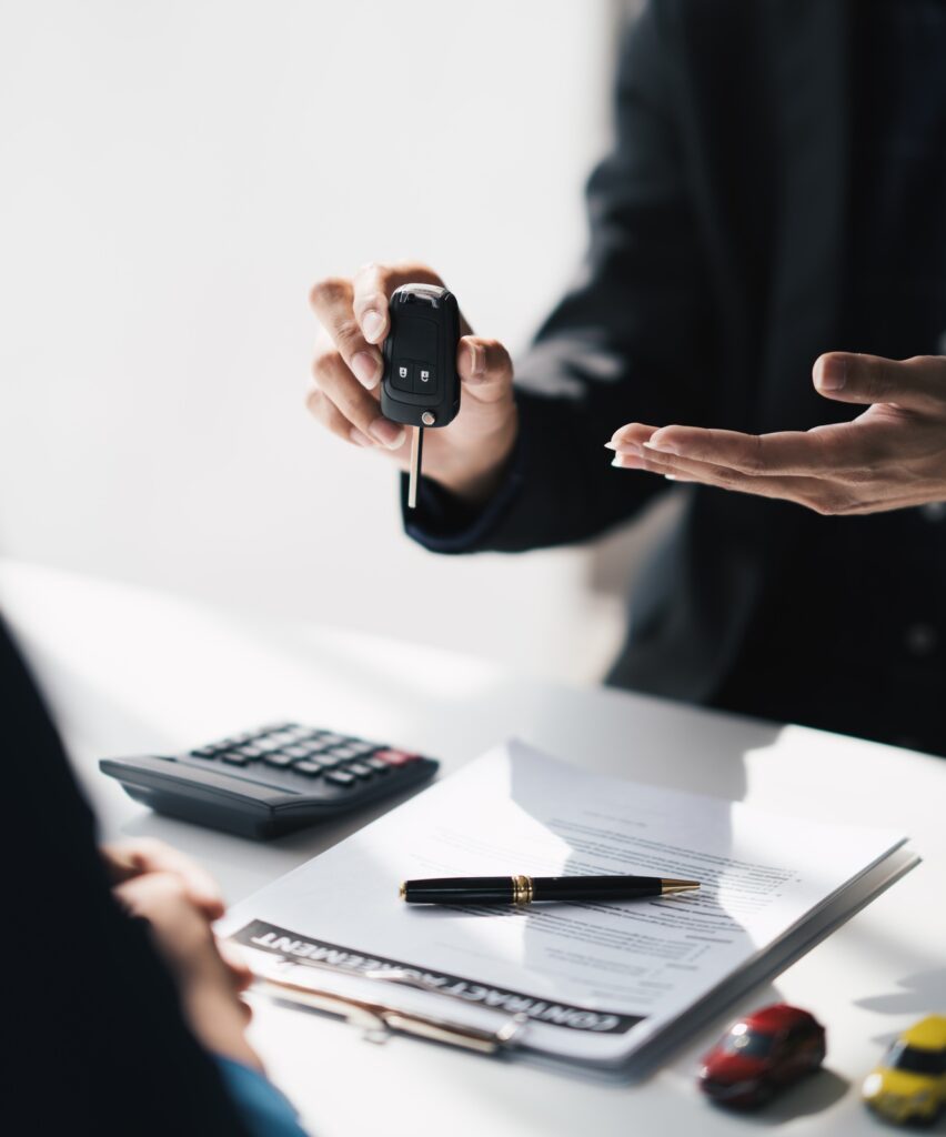 Business car rental, sell or buy service, salesman giving auto key of vehicle to customer after the